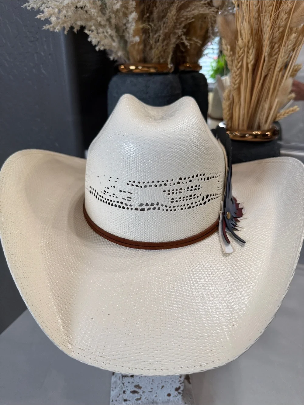 White Straw Cowboy Hat with Patriotic Red White and Blue Feathers.